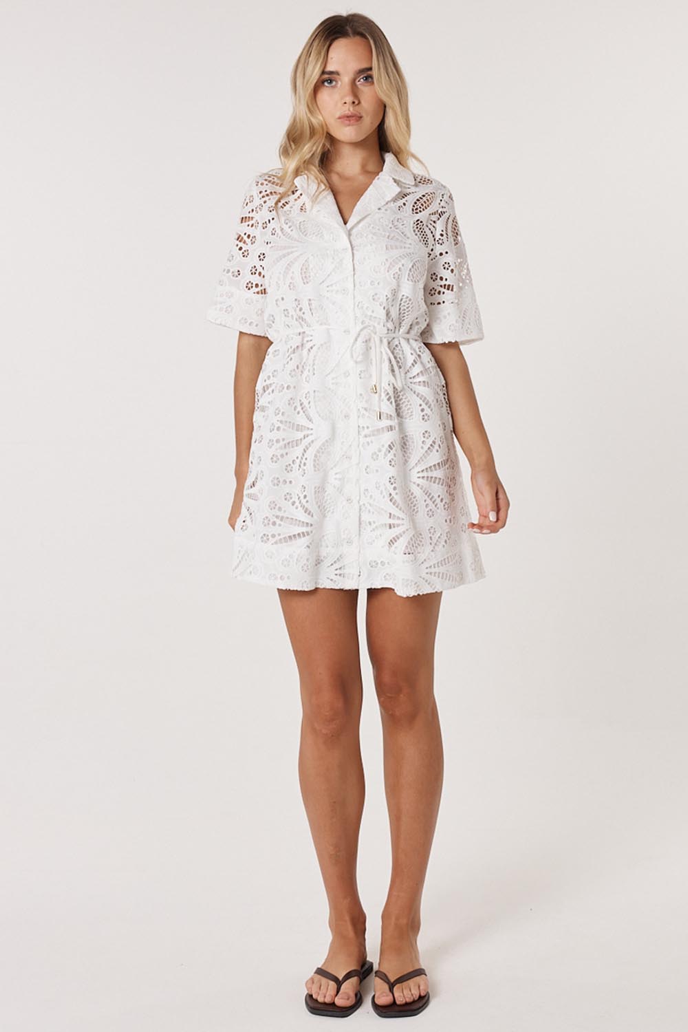 A model wearing the Elara Broderie Shirt Dress in colour Ivory (White), from the front, showing the whole outfit