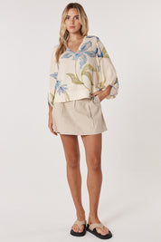 A model wearing the Anthea Linen Blend Blouse in colour Floral (White), from the front, showing the whole outfit
