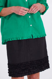 Model Emma wearing size 10 of the Frill Hem Pull On Linen Skirt in colour Black (Black), from the front, cropped image