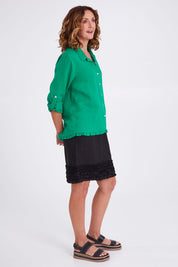 Model Emma wearing size 10 of the Frill Hem Pull On Linen Skirt in colour Black (Black), from the front, showing the whole outfit
