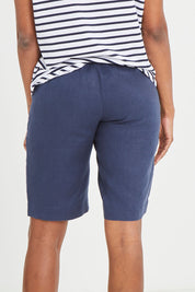 Model Aiyana wearing size 10 of the Pull On Linen Short in colour Marine (Blue), from the back