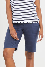 Model Aiyana wearing size 10 of the Pull On Linen Short in colour Marine (Blue), from the front, cropped image