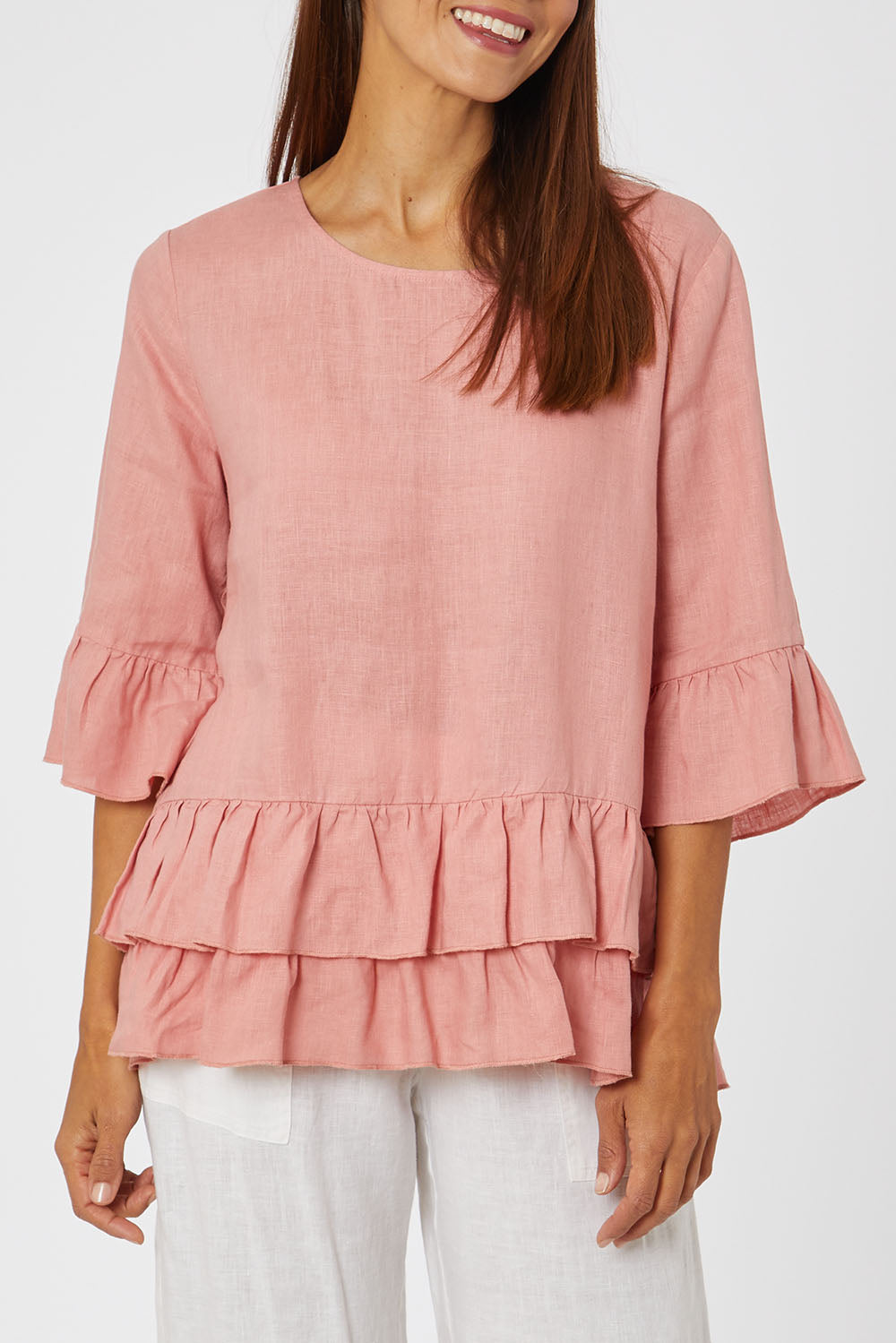 Model Cara wearing size 10 of the Frilled Hem Top in colour Rose (Pink), from the front, cropped image