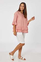 Model Cara wearing size 10 of the Frilled Hem Top in colour Rose (Pink), from the front, showing the whole outfit