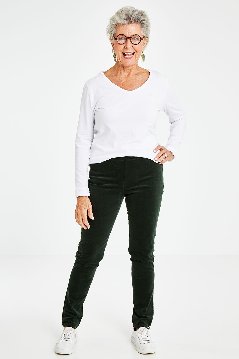 Model Elise wearing size 10 of the Stretch Pinwale Cord Pant in colour Emerald (Green), from the front, showing the whole outfit
