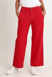 Model Riina wearing size 10 of the Hudson Wide Leg Jean in colour Red (Red), from the front, cropped image
