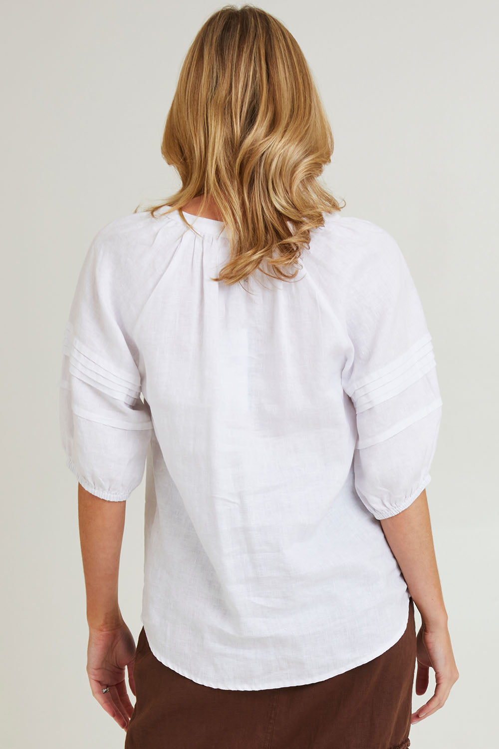 Model Grace wearing size 10 of the Diana Linen Top in colour White (White), from the back