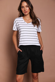 Model Madeline wearing size 10 of the Jersey Waist Linen Short in colour Black (Black), from the front, cropped image