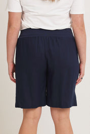 Model Chanel wearing size 16 of the Jersey Waist Linen Short in colour Navy (Blue), from the back