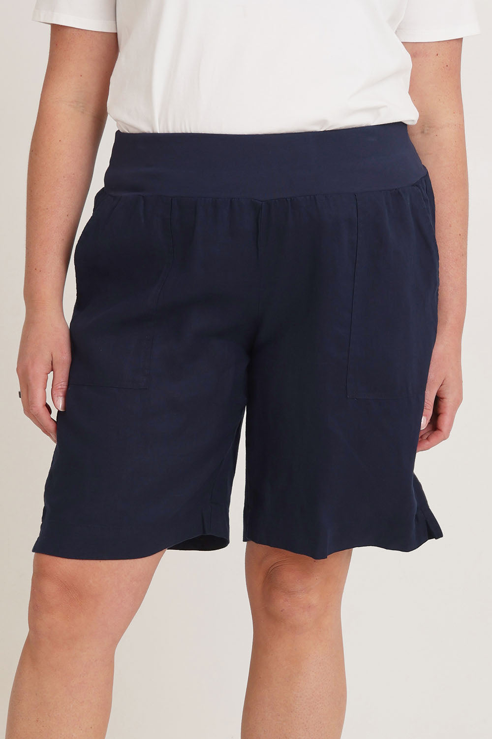 Model Chanel wearing size 16 of the Jersey Waist Linen Short in colour Navy (Blue), from the front, cropped image