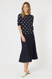 A model wearing the Kate Knit Long Skirt in colour Navy (Blue), from the front, showing the whole outfit