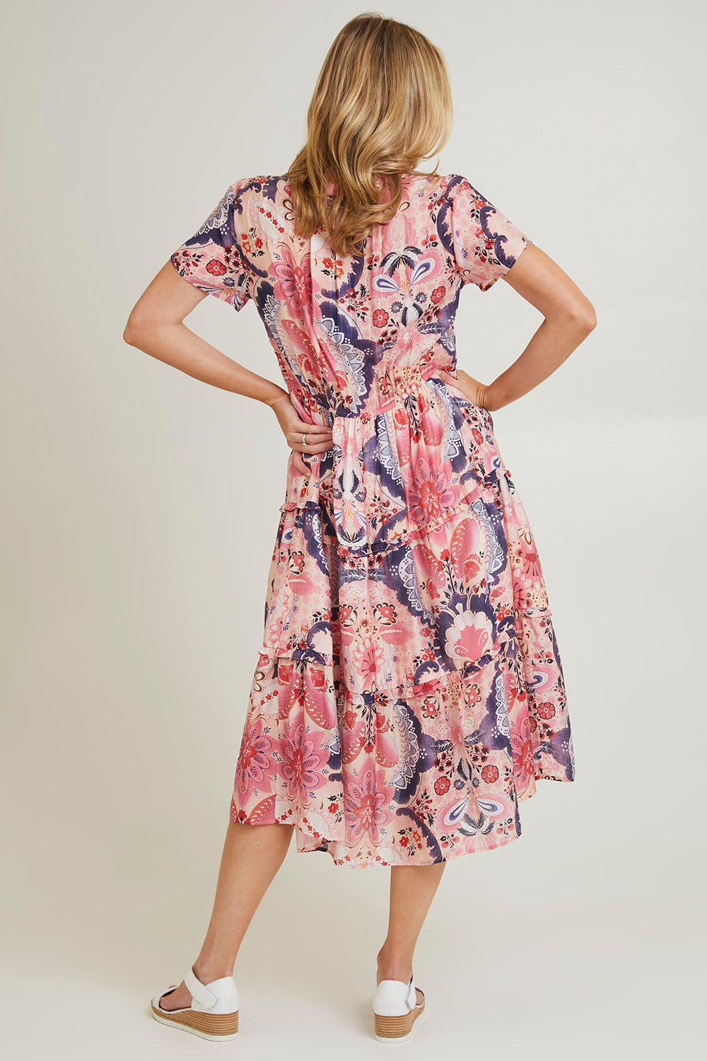 Model Grace wearing size 10 of the Newport Dress in colour Coral (Pink), from the back