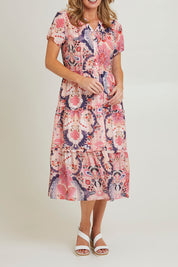 Model Grace wearing size 10 of the Newport Dress in colour Coral (Pink), from the front, cropped image