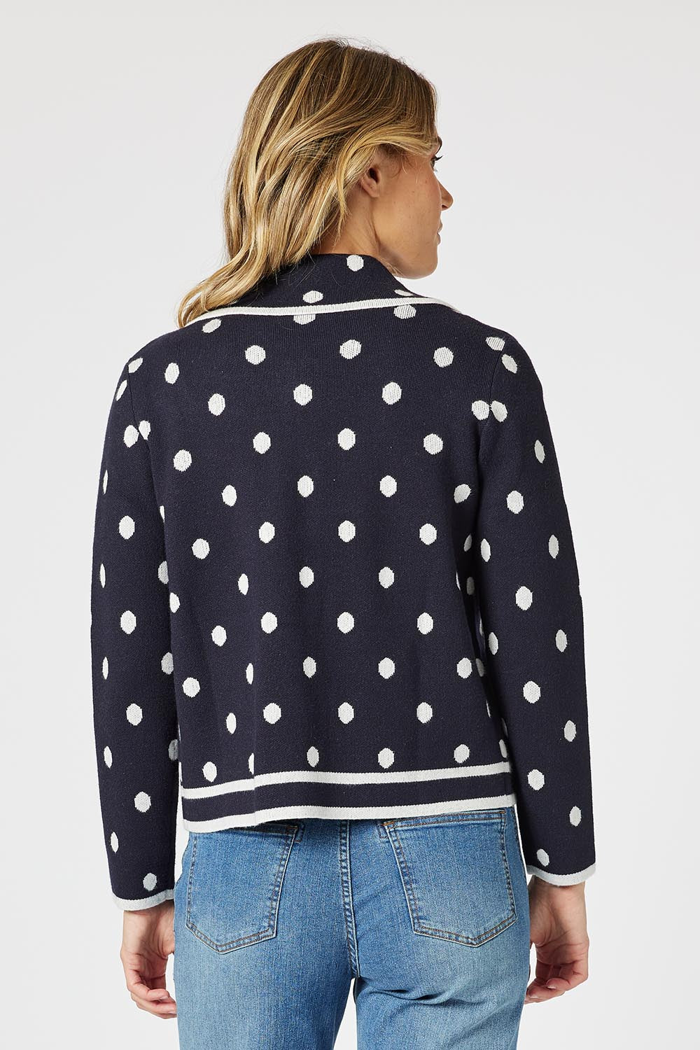 A model wearing the Ascot Cardigan in colour Navy (Blue), from the back