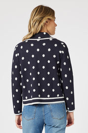 A model wearing the Ascot Cardigan in colour Navy (Blue), from the back