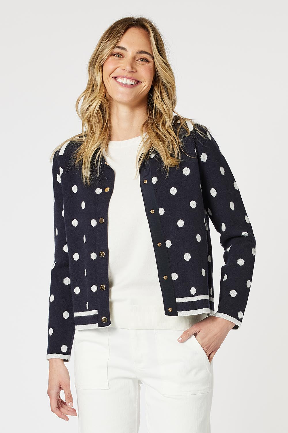A model wearing the Ascot Cardigan in colour Navy (Blue), from the front, cropped image