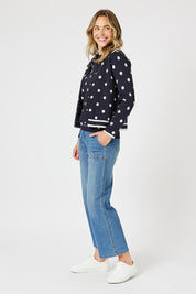 A model wearing the Ascot Cardigan in colour Navy (Blue), from the front, showing the whole outfit
