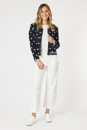A model wearing the Ascot Cardigan in colour Navy (Blue), from the front, showing the whole outfit