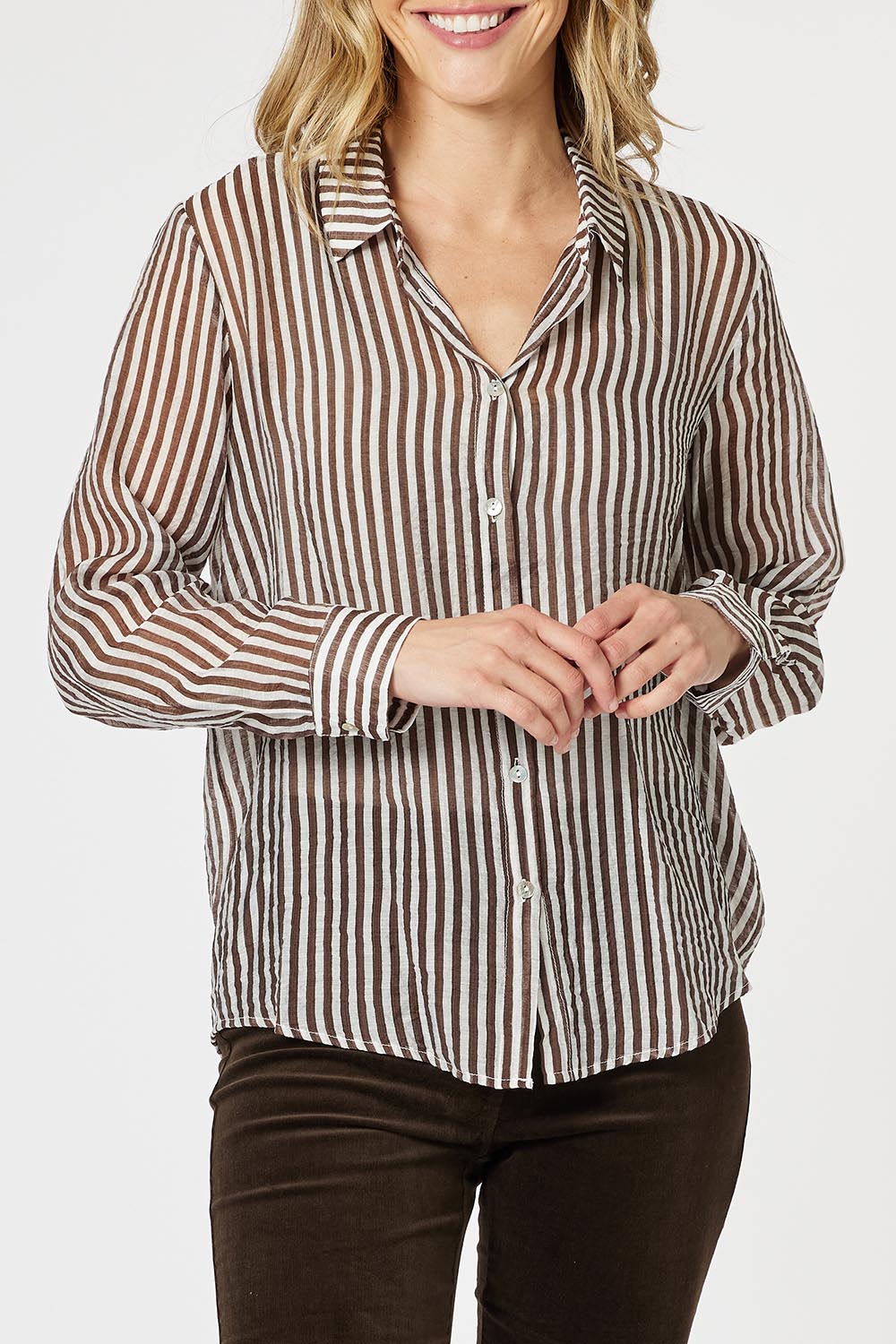 A model wearing the City Stripe Shirt in colour Chocolate, from the front, cropped image
