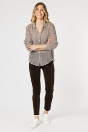 A model wearing the City Stripe Shirt in colour Chocolate, from the front, showing the whole outfit