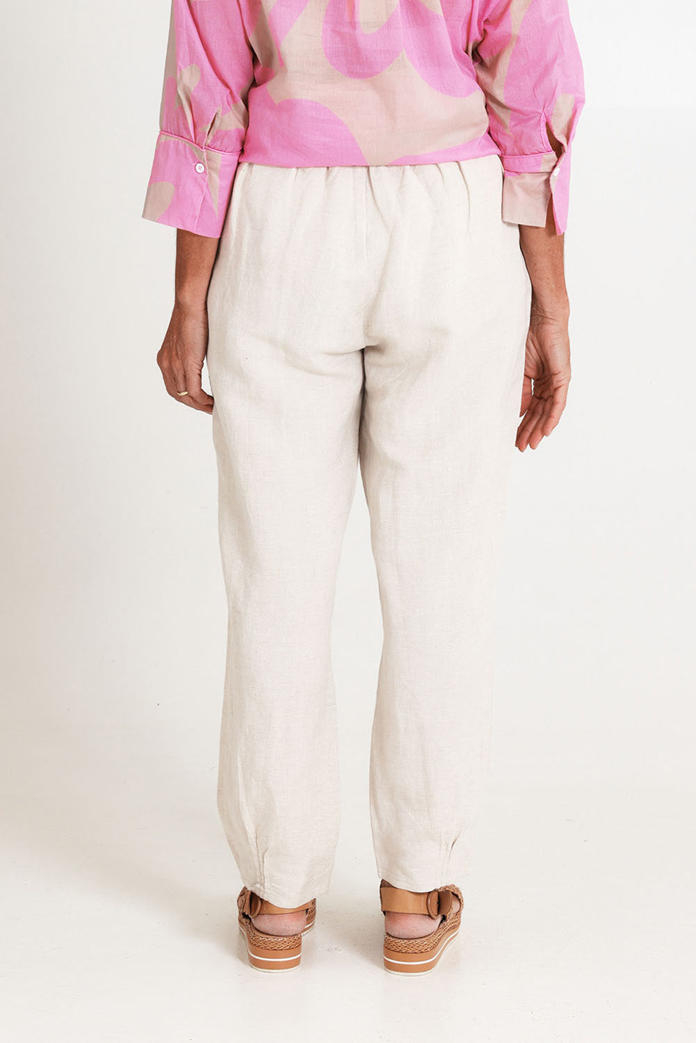 Model Sandy wearing size 10 of the Lino Linen Blend Tapered Pant in colour Natural, from the back