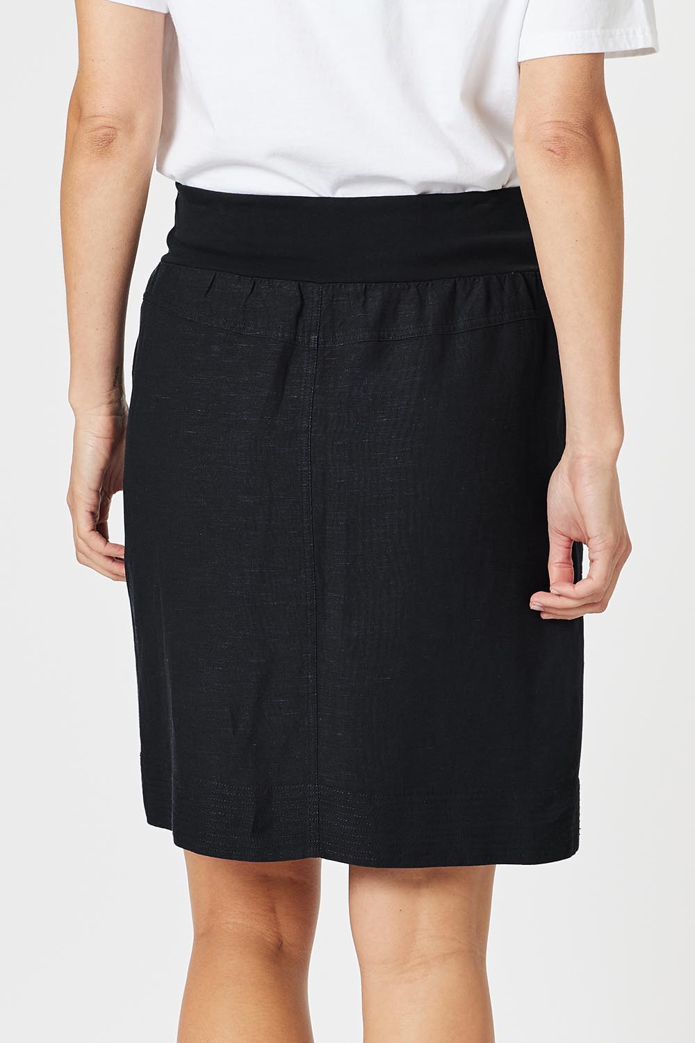 A model wearing the Lino Linen Blend Skirt in colour Black (Black), from the back