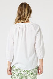 A model wearing the Coastal Embroidered Cotton Top in colour White (White), from the back