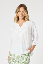 A model wearing the Coastal Embroidered Cotton Top in colour White (White), from the front, cropped image