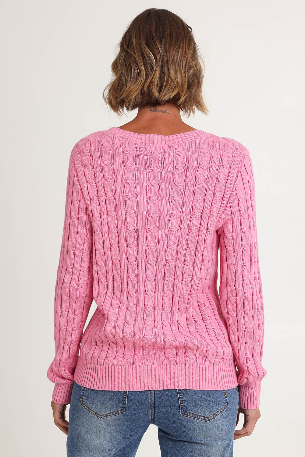 Model Riina wearing size S of the Hampton Cable Knit Jumper in colour Pink (Pink), from the back