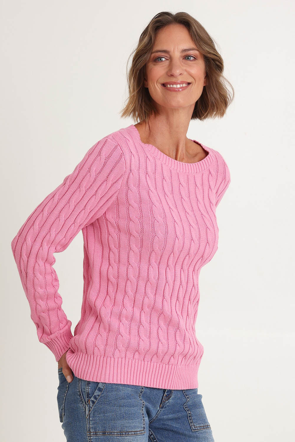 Model Riina wearing size S of the Hampton Cable Knit Jumper in colour Pink (Pink), from the front, cropped image