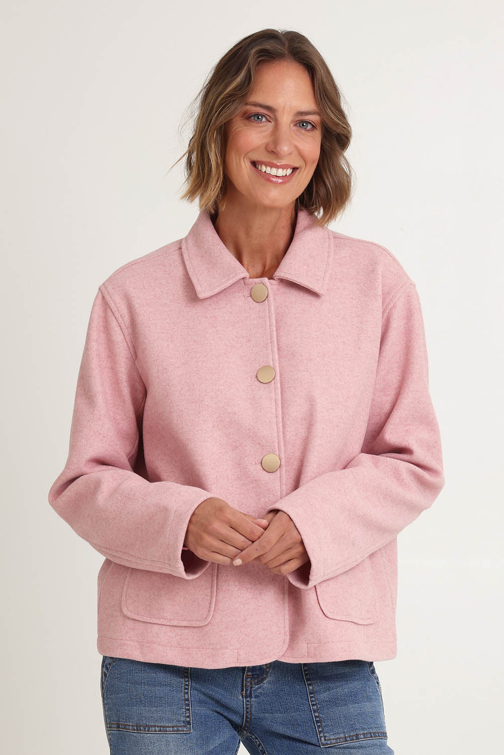 Model Riina wearing size 10 of the Montana Car Coat in colour Blush (Pink), from the front, cropped image