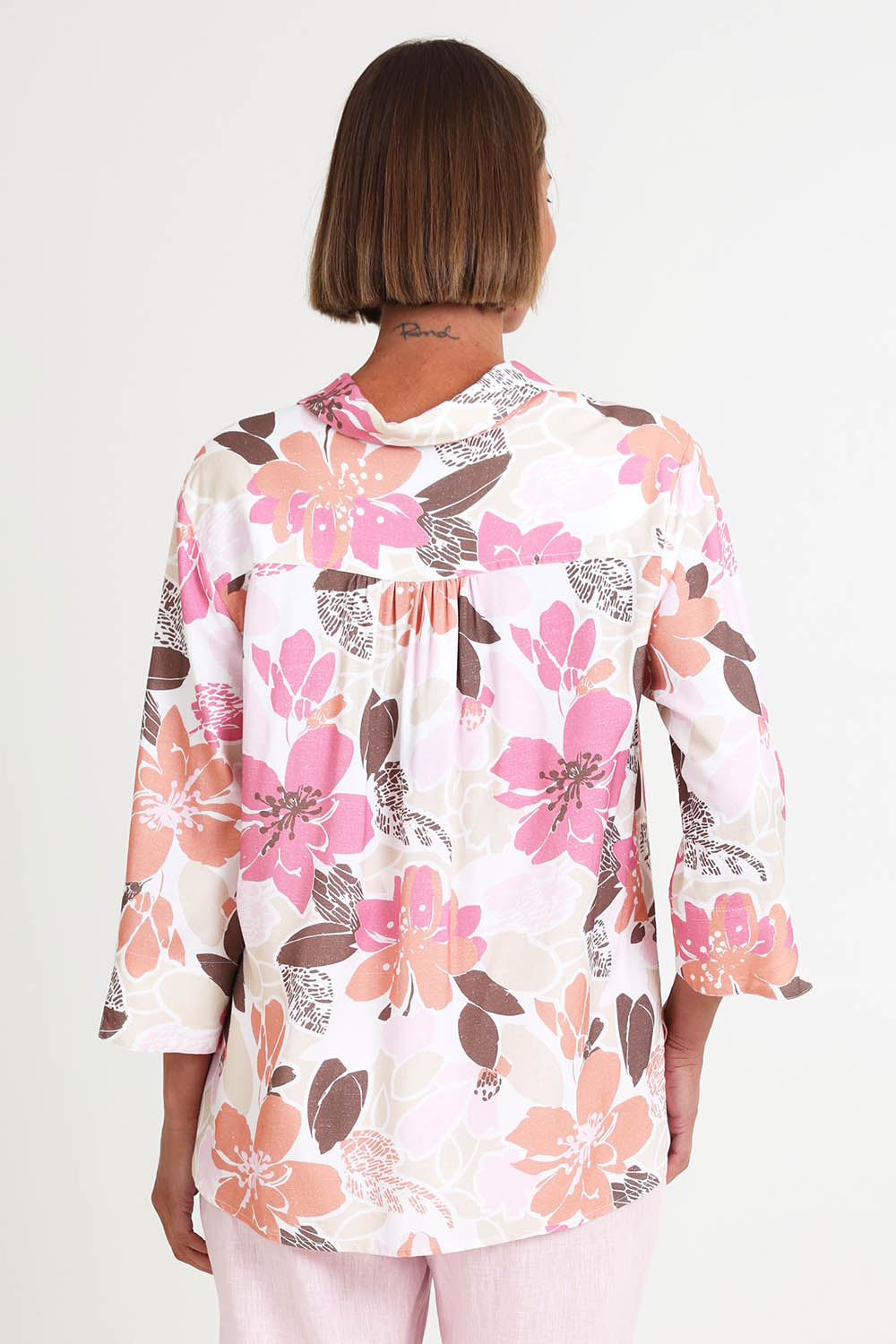 Model Riinar wearing size 10 of the Amalfi Rose Print Shirt – Pinkmulti in colour Pinkmulti, from the back