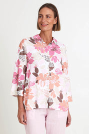 Model Riinar wearing size 10 of the Amalfi Rose Print Shirt – Pinkmulti in colour Pinkmulti, in a cropped view