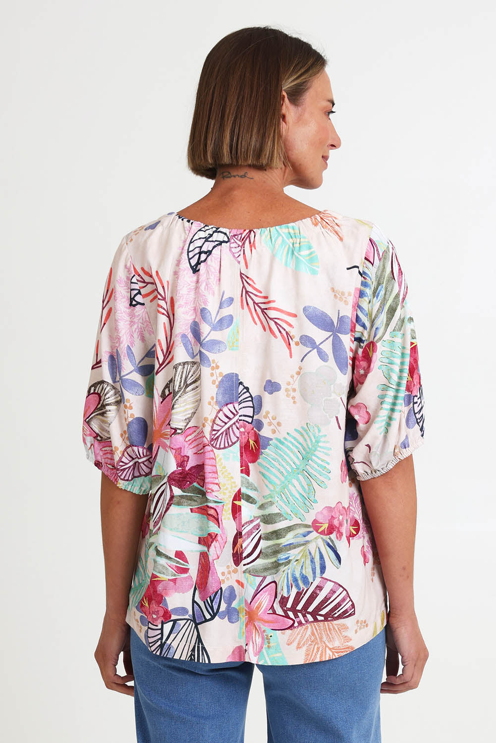 Model Riinar wearing size 10 of the Desert Rose Print Top – Pinkmulti in colour Pinkmulti, from the back