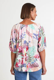 Model Riinar wearing size 10 of the Desert Rose Print Top – Pinkmulti in colour Pinkmulti, from the back
