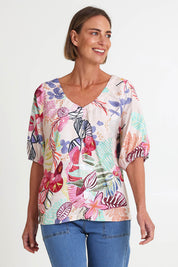 Model Riinar wearing size 10 of the Desert Rose Print Top – Pinkmulti in colour Pinkmulti, in a cropped view