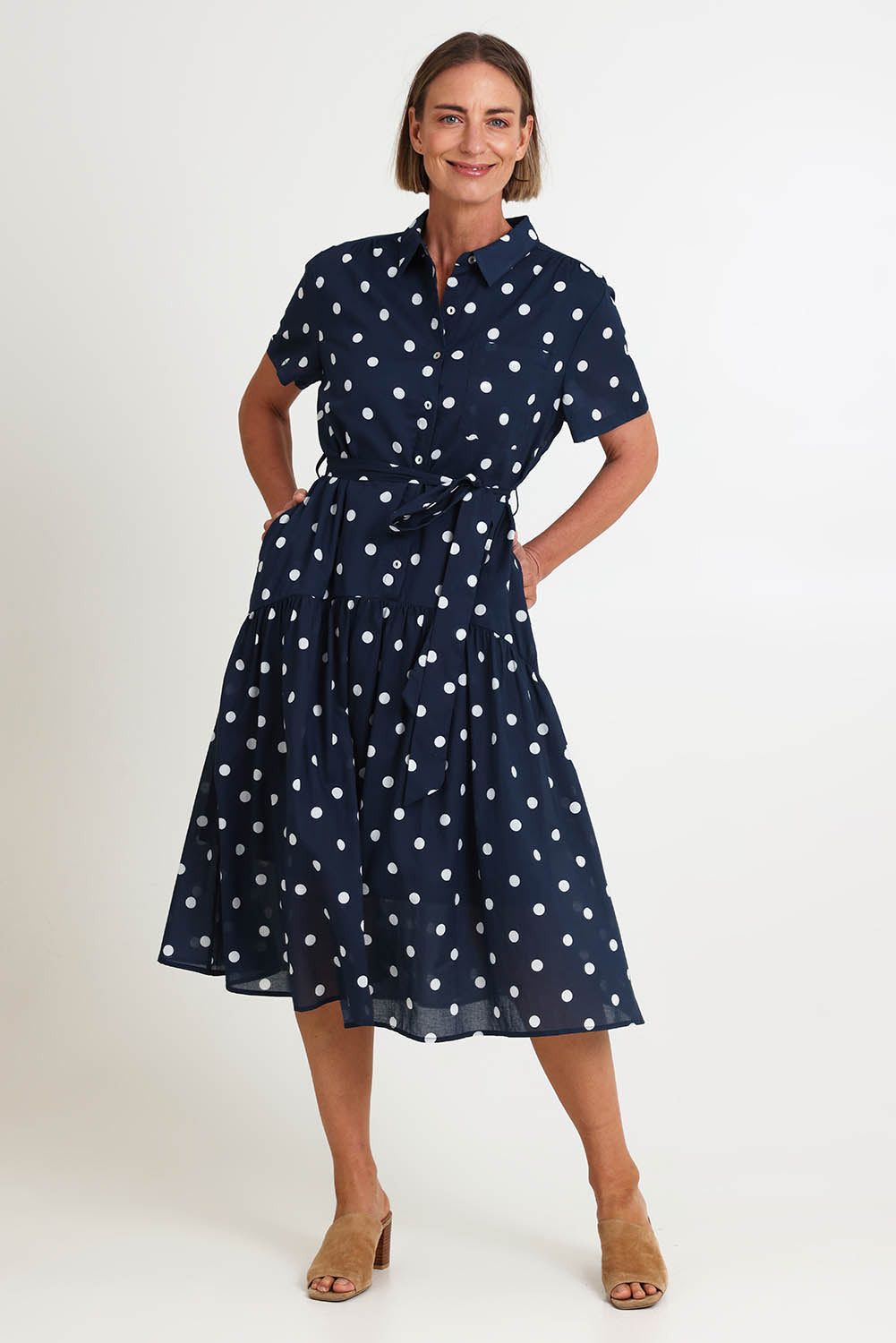 Model Riinar wearing size 10 of the Riviera Spot Dress – Navywhite in colour Navywhite, from the front