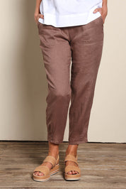 Model Riinar wearing size 10 of the Pull On Linen Pant - Mocha in colour Mocha, in a cropped view