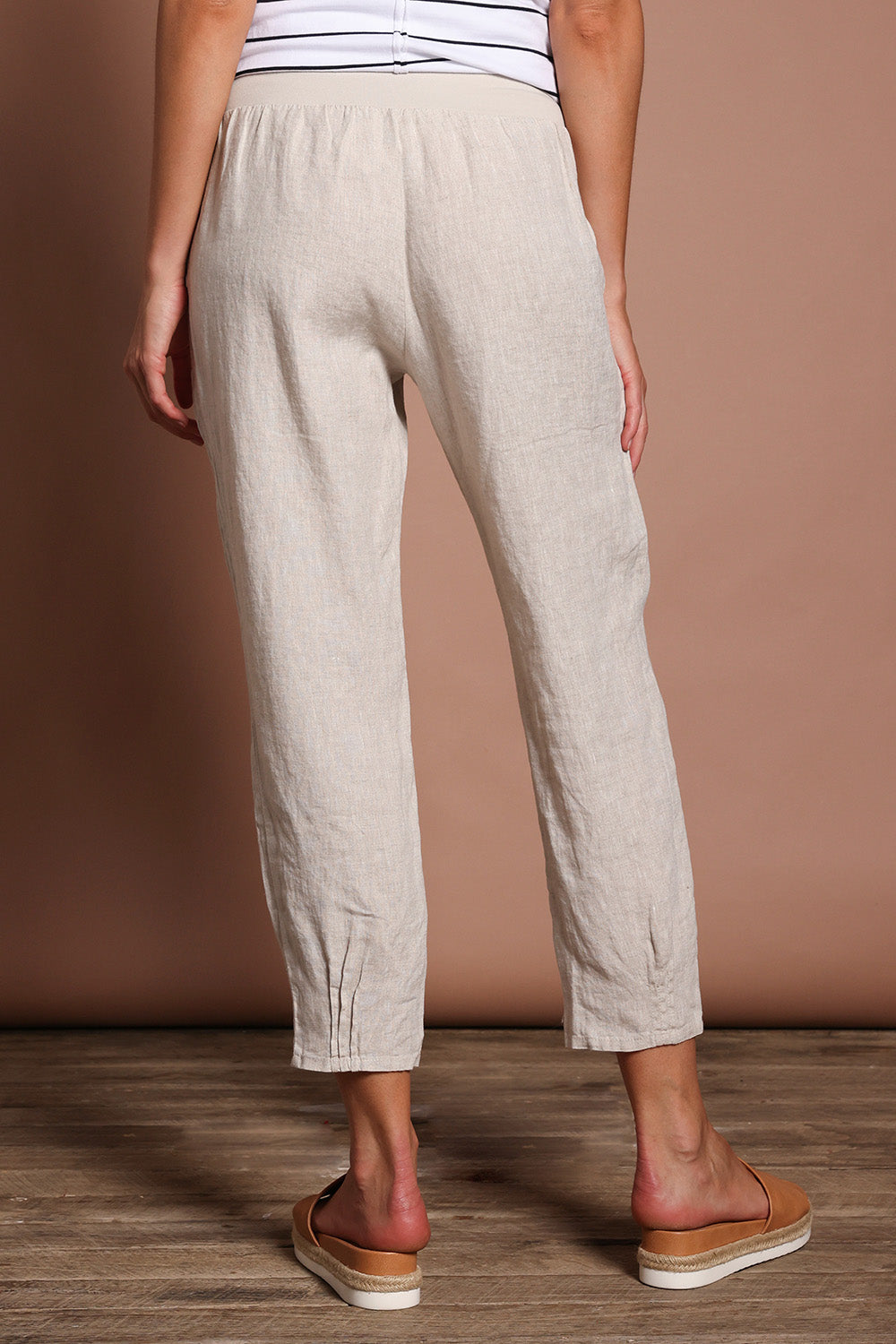 Model Madeline wearing size 10 of the Pull On Linen Pant in colour Natural, from the back