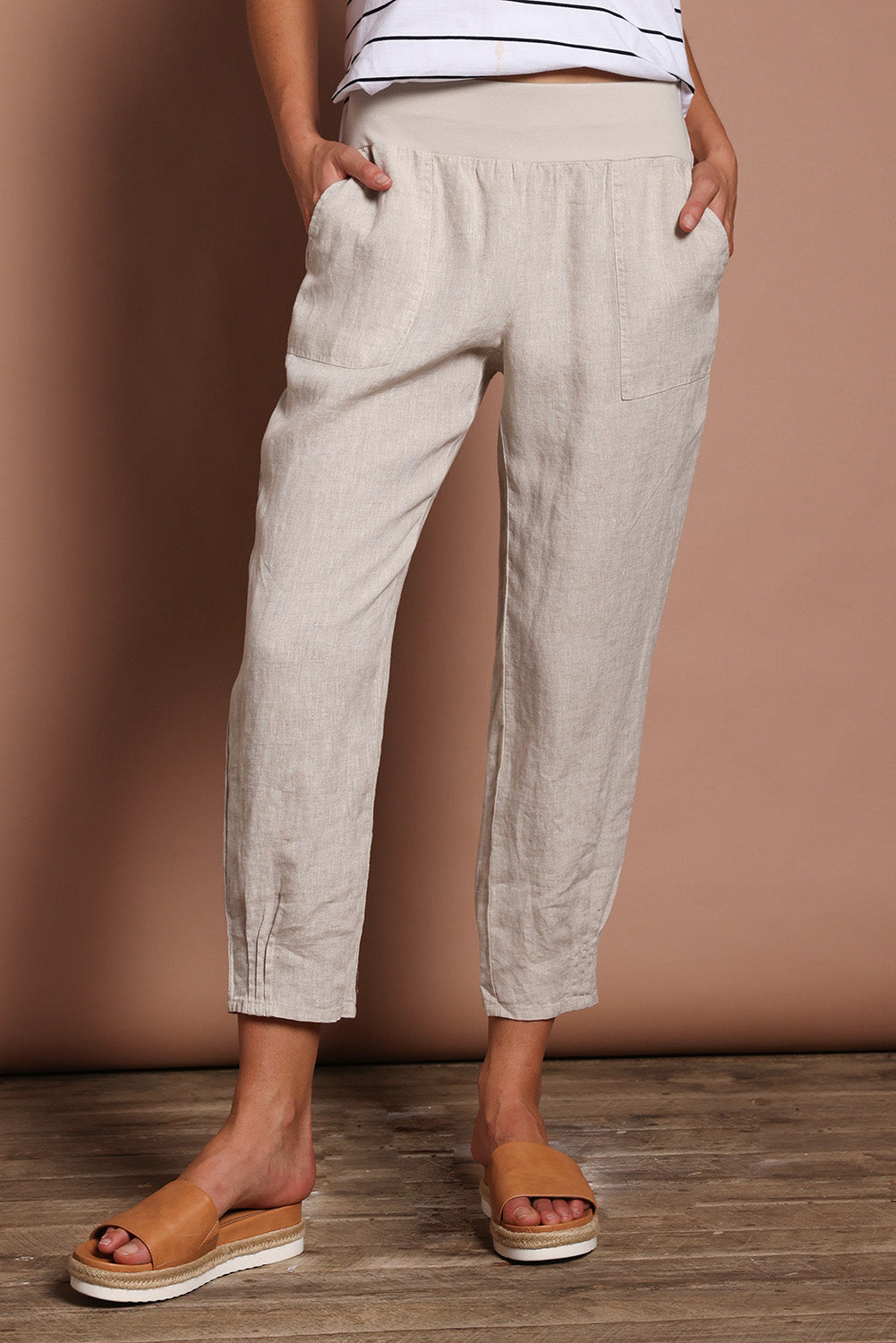 Model Madeline wearing size 10 of the Pull On Linen Pant in colour Natural, from the front, cropped image