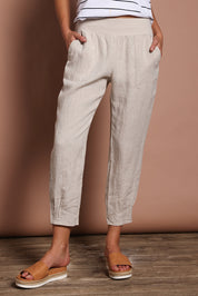 Model Madeline wearing size 10 of the Pull On Linen Pant in colour Natural, from the front, cropped image