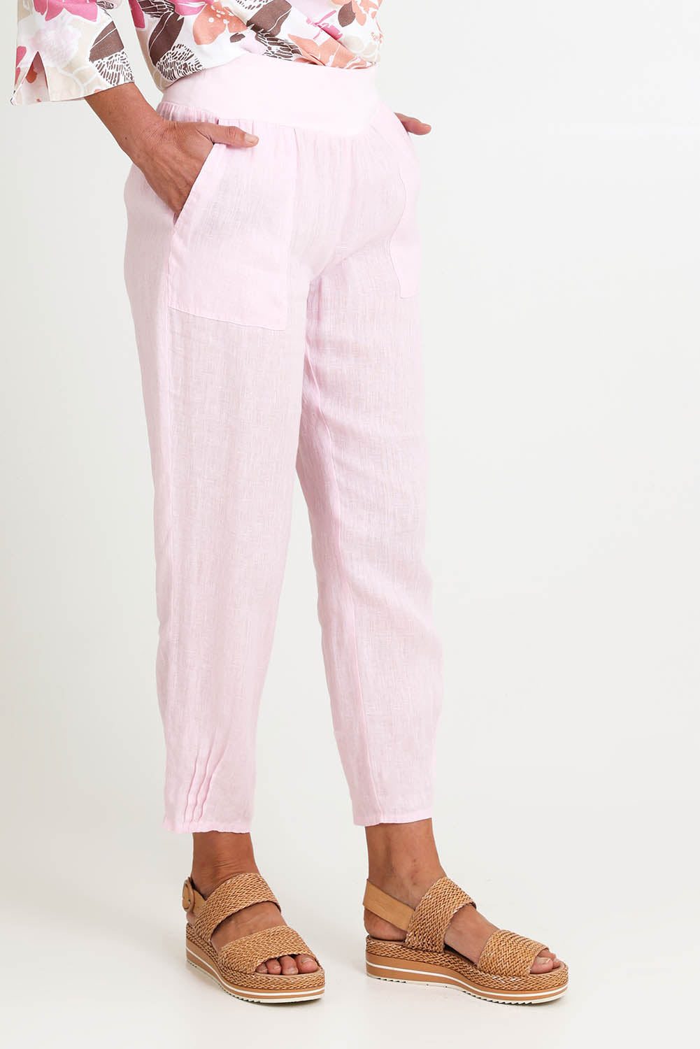 Model Riinar wearing size 10 of the Pull On Linen Pant - Palepink in colour Palepink, from an angle