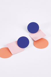 A model wearing size OneSize of the Tri Geo Earrings in colour Multi (Pink), from the front, showing the whole outfit