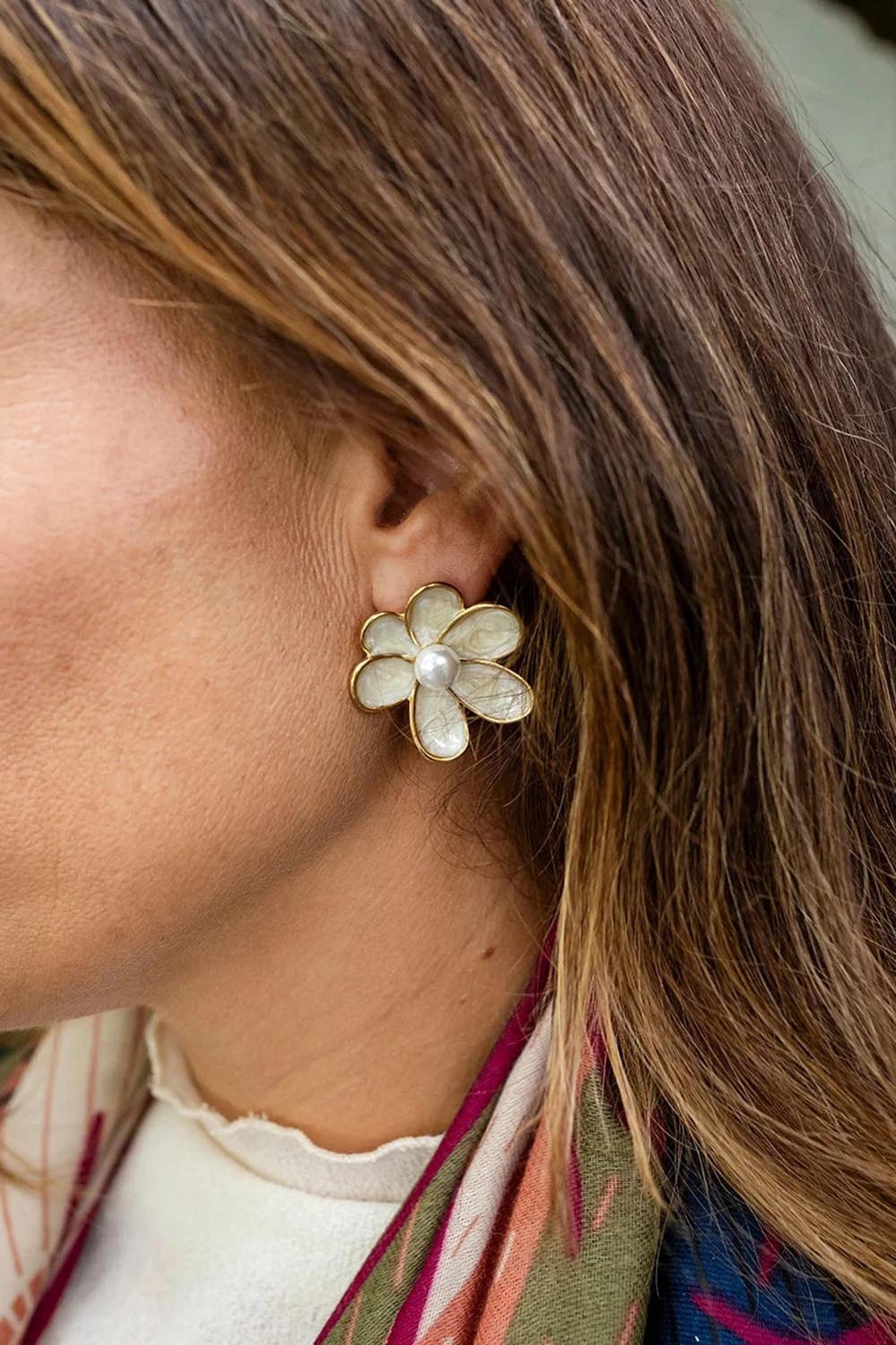 Model Genericm wearing size sample of the Bronte Flower Stud Earring - White in colour White, from an angle