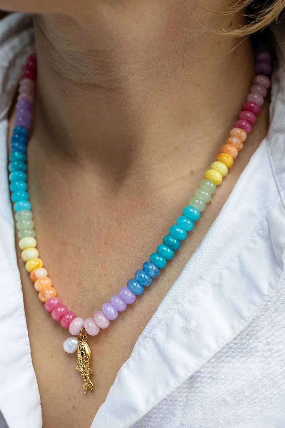 Model Genericm wearing size sample of the Fish & Pearl Necklace - Brights in colour Brights, in a cropped view