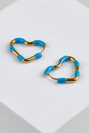 Model Genericm wearing size sample of the Hannah Heart Hoop Earring - Blue in colour Blue, in a cropped view