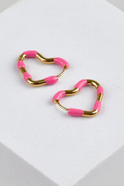 Model Genericm wearing size sample of the Hannah Heart Hoop Earring - Hotpink in colour Hotpink, in a cropped view