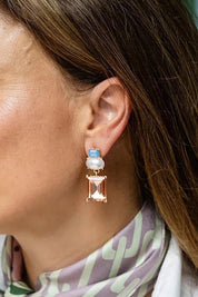 Model Genericm wearing size sample of the Matilda Geometric Crystal Earring - Bluepeach in colour Bluepeach, from an angle