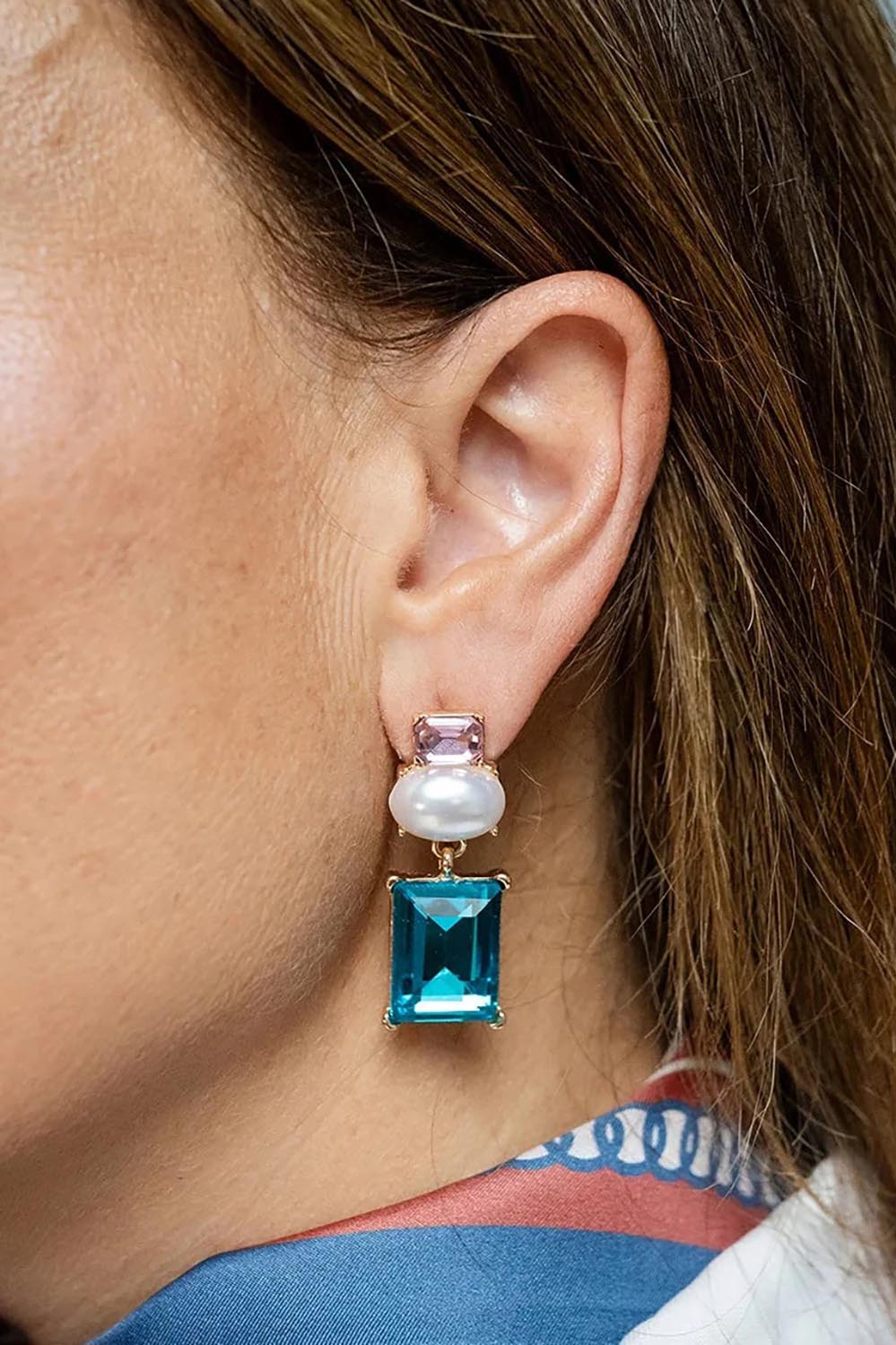 Model Genericm wearing size sample of the Matilda Geometric Crystal Earring - Pinkteal in colour Pinkteal, from an angle