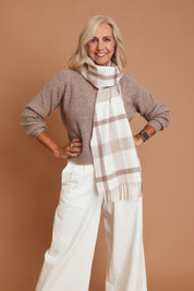 Model Sandy wearing the Mila Check Scarf in colour Natural, from the front, cropped image